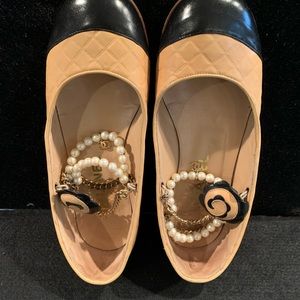 Chanel beige and black flats with pearls and CC . charm